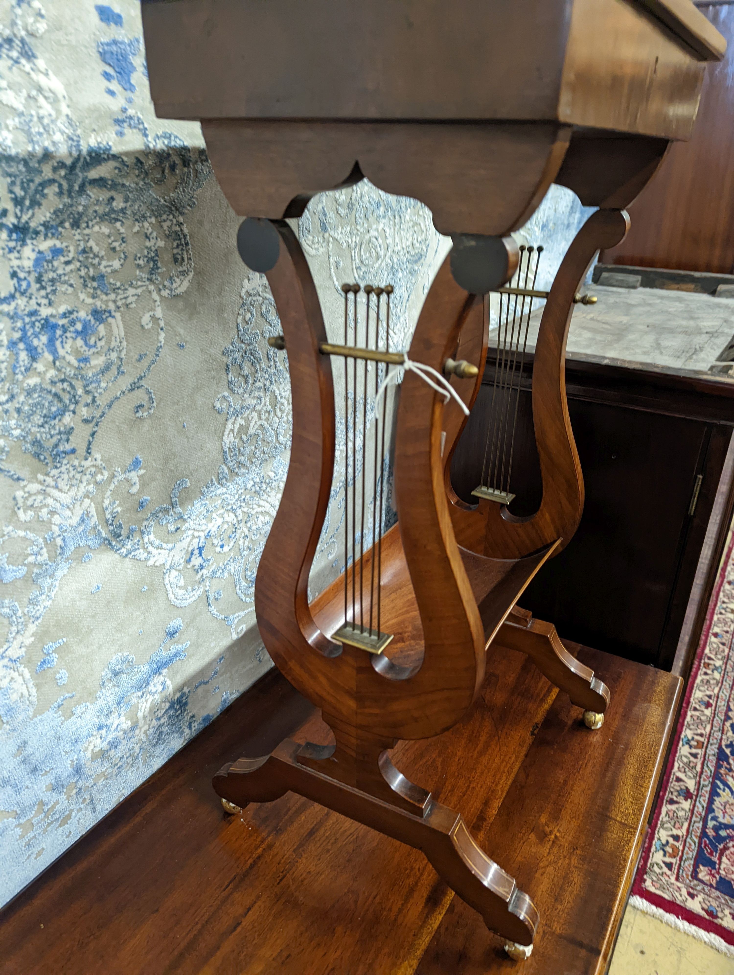 A reproduction Regency style mahogany work table on lyre supports, width 39cm, depth 27cm, height 69cm